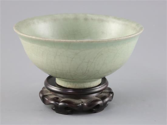 A Chinese Longquan celadon bowl, Ming dynasty, D. 18.5cm, crackle to glaze, wood stand